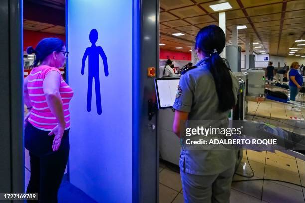 Passenger goes through a body scanner at Havana's Jose Marti airport on October 12, 2023.