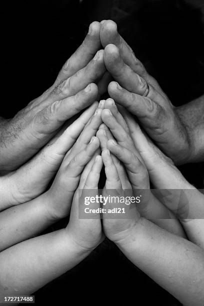 fitting the mold - black and white hands stock pictures, royalty-free photos & images