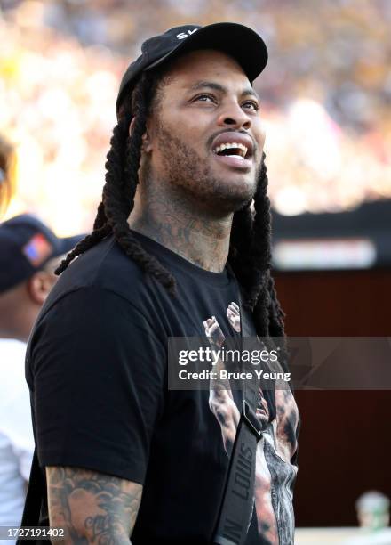 American rapper Waka Flocka Flame looks up at the jumbotron during a timeout in the first quarter of the University of Colorado Buffs versus the...