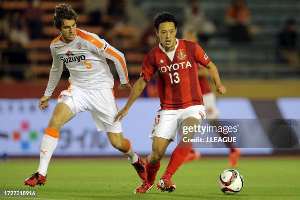 Ryota Isomura of Nagoya Grampus controls the ball against Dejan Jakovic of Shimizu S-Pulse during the J.League J1 first stage match between Nagoya...