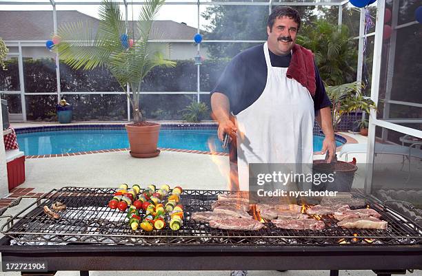 barbecue cooking - apron man stock pictures, royalty-free photos & images