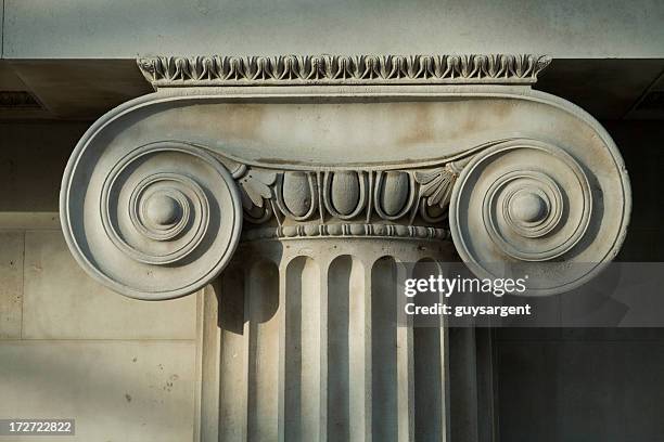 scrolled stone column. - museum sculpture stock pictures, royalty-free photos & images