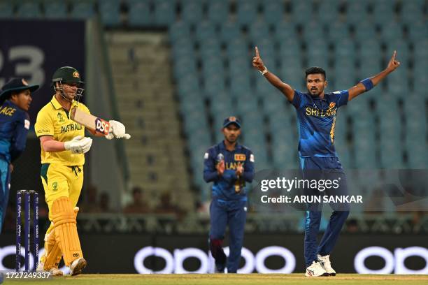 Sri Lanka's Dilshan Madushanka celebrates after taking the wicket of Australia's David Warner during the 2023 ICC Men's Cricket World Cup one-day...