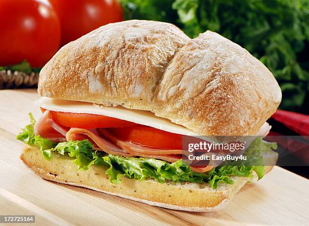 ham lettuce tomato and provolone on a fresh baguette - ciabatta stockfoto's en -beelden