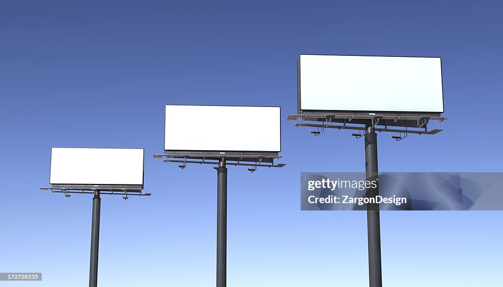 Three billboards isolated against blue sky