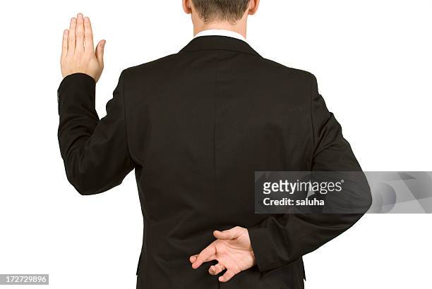 man in suit taking oath while crossing fingers behind back - ed bildbanksfoton och bilder