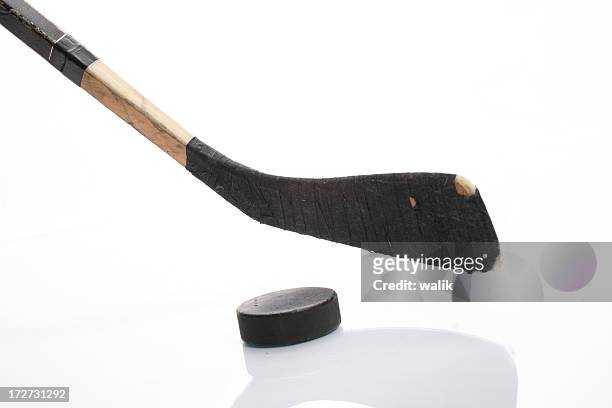 close up of hockey stick and puck on white background - hockey puck stock pictures, royalty-free photos & images