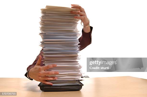 office worker holding paperwork stack - administrative professional stock pictures, royalty-free photos & images