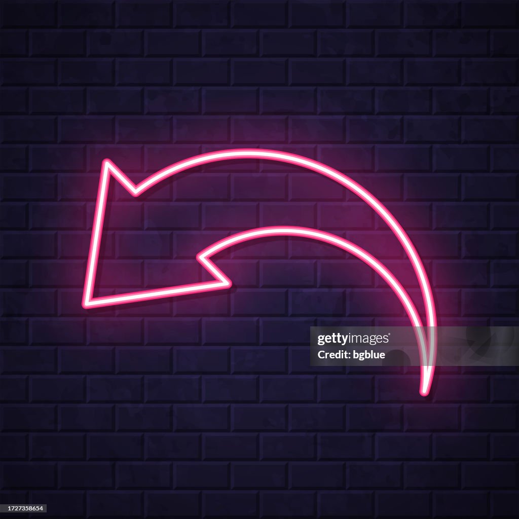 Undo. Glowing neon icon on brick wall background