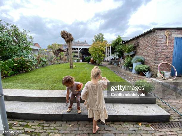 grandchildren watching the garden - sod field stock pictures, royalty-free photos & images