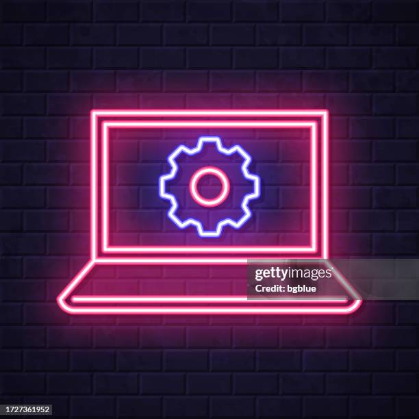 laptop settings - gears. glowing neon icon on brick wall background - wall panel stock illustrations