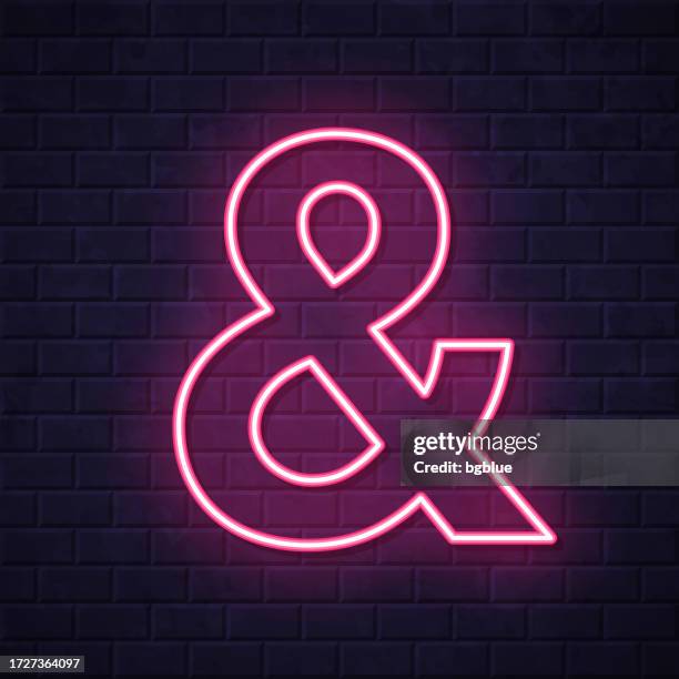ampersand symbol. glowing neon icon on brick wall background - ampersand stock illustrations