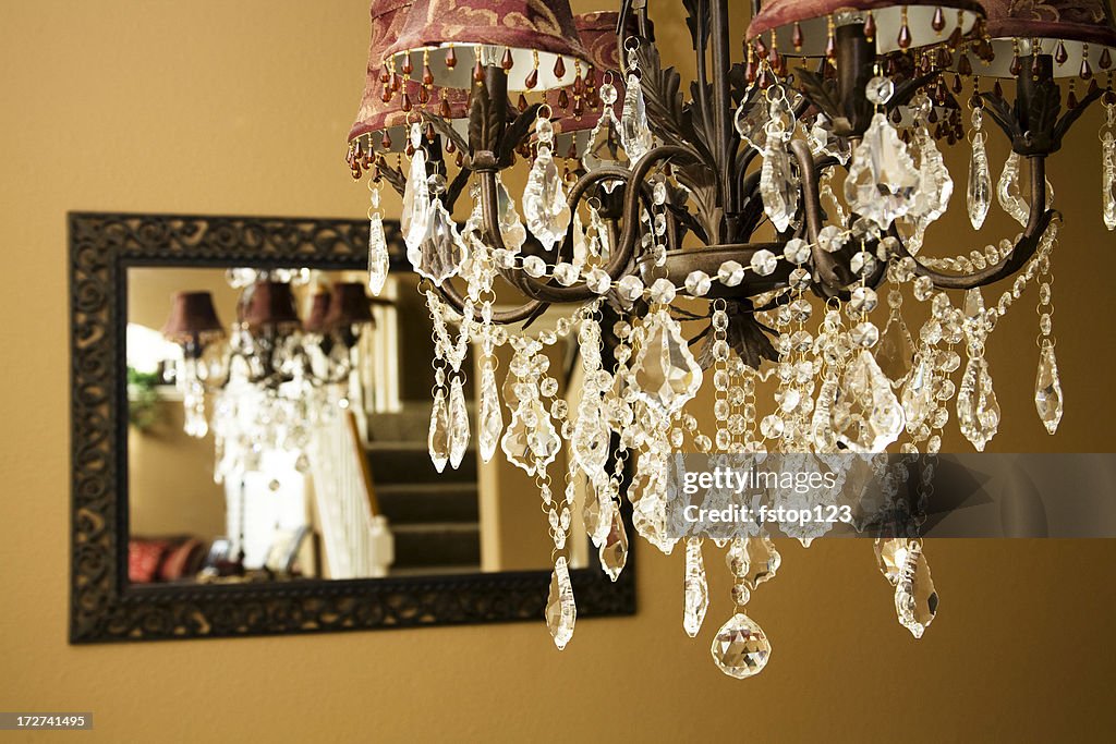 Crystal chandelier. Dining room. Reflection in mirror. Luxury, elegance.