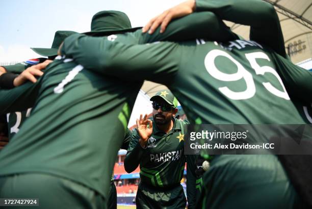 Babar Azam of Pakistan speaks to his teammates in a huddle prior to the ICC Men's Cricket World Cup India 2023 between Pakistan and Sri Lanka at...