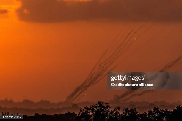 October 2023, Israel, Sderot: Rockets are fired from the Gaza Strip towards Israel during the sunset as fighting between Israeli troops and Islamist...