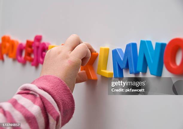 learning the alphabet - spelling stockfoto's en -beelden