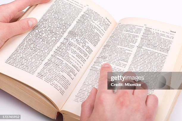 student's hand pointing at a word - woordenboek stockfoto's en -beelden