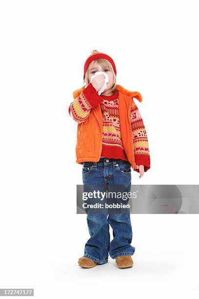 little girl with cold blowing nose. - tissue stockfoto's en -beelden