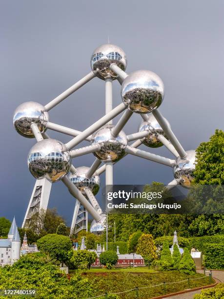 the atomium in brussels under a stormy sky - atomium monument stock pictures, royalty-free photos & images
