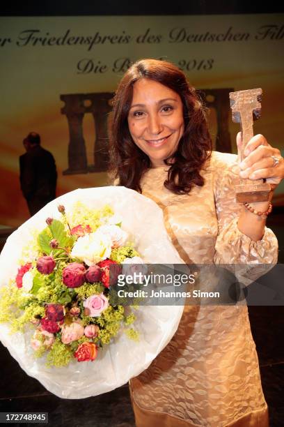 Saudi Arabian director and award winner Haifaa al-Mansour poses with the award trophy after the Bernhard Wicki Award ceremony at Munich film festival...