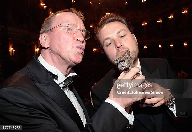 German actor and award winner Daniel Harrich and Ulrich Chaussy pose with the award trophy after the Bernhard Wicki Award ceremony at Munich film...