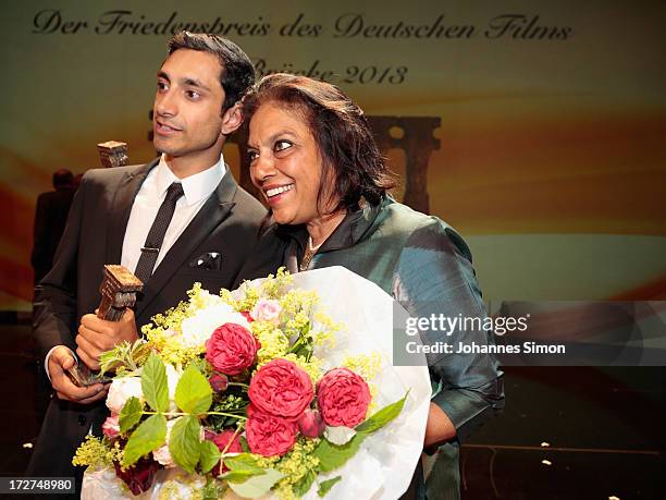 Award winners British actor with Pakistan origins Riz Ahmed and Indian director Mira Nair pose with the award trophy after the Bernhard Wicki Award...