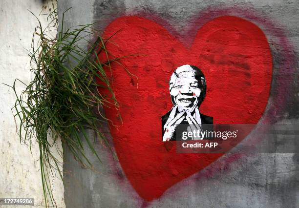 Heart-shaped street art depicting former South African President Nelson Mandela is seen in Cape Town on July 4, 2013. During a nearly one month...