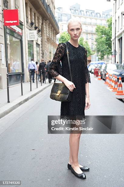 Model Yulia Lobova wears a Dolce and Gabbana dress, Celine bag and Chanel shoes on day 4 of Paris Collections: Womens Haute Couture on July 04, 2013...