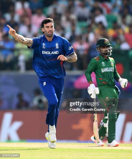 Reece Topley of England celebrates after dismissing Tanzid Hasan of Bangladesh during the ICC Men's Cricket World Cup India 2023 between England and...
