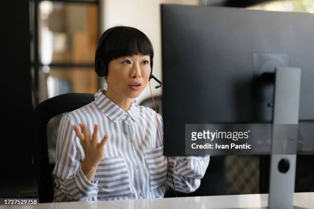 asian customer service representative working in a call center. - represented stock pictures, royalty-free photos & images