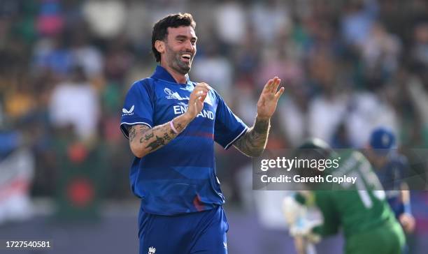 Reece Topley of England celebrates after dismissing Shakib Al Hasan of Bangladesh during the ICC Men's Cricket World Cup India 2023 between England...