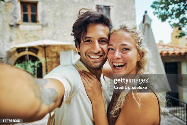 casal millennial feliz, explorando a vila histórica de eze, no sul da frança, durante as férias. - eze village - fotografias e filmes do acervo