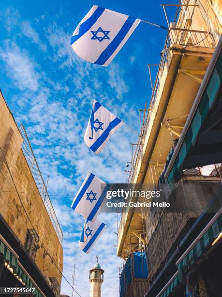 israeli flags against blue sky in jerusalem - jerusalem old city stock pictures, royalty-free photos & images