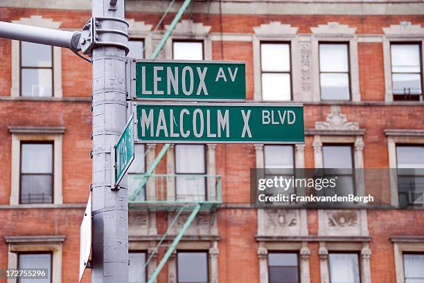harlem malcolm x blvd street sign - harlem new york stock pictures, royalty-free photos & images