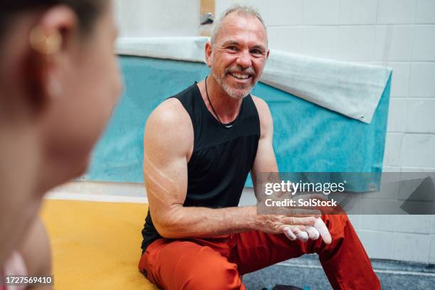 man enjoying a day at the climbing centre - rubbing hands together stock pictures, royalty-free photos & images