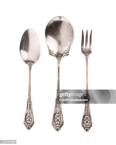 antique silver spoons and fork on white background - eetgerei stockfoto's en -beelden