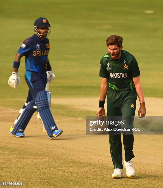 Kusal Mendis of Sri Lanka celebrates their century alongside teammate Sadeera Samarawickrama during the ICC Men's Cricket World Cup India 2023...
