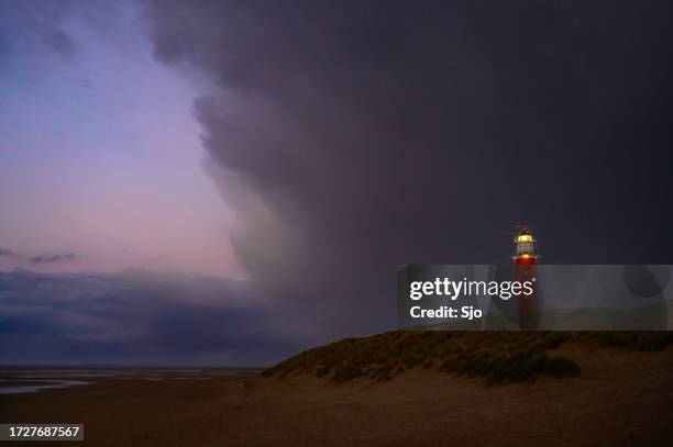 texel lighthouse in the dunes during a calm autumn afternoon - calm before the storm stock pictures, royalty-free photos & images