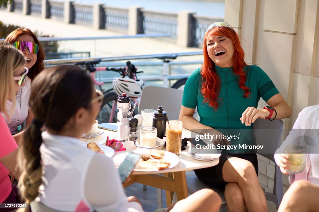 Female teammates getting breakfast together after morning bicycle training