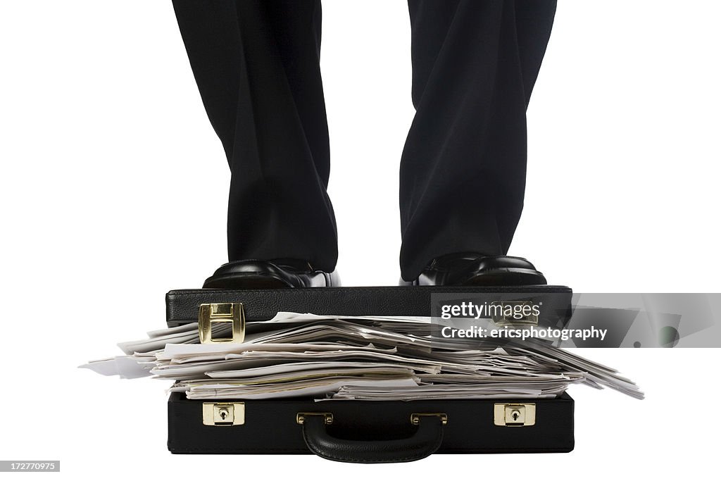 Man in suit standing on documents