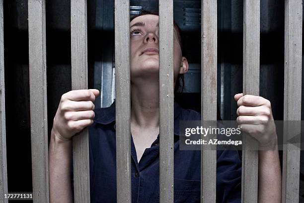 woman in cage - security screen stockfoto's en -beelden