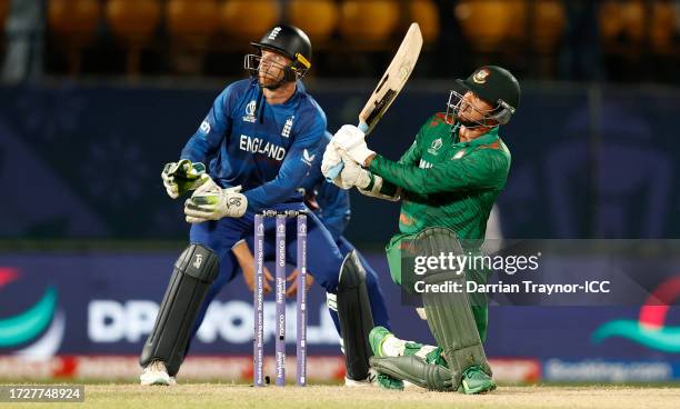 Taskin Ahmed of Pakistan hits a six as Jos Buttler of England keeps during the ICC Men's Cricket World Cup India 2023 between England and Bangladesh...