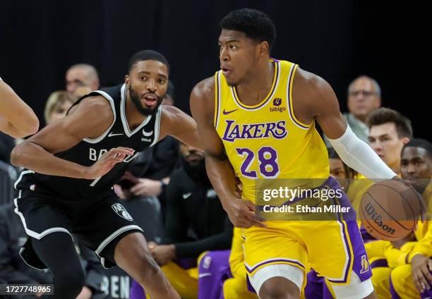 Rui Hachimura of the Los Angeles Lakers is guarded by Mikal Bridges of the Brooklyn Nets in the first quarter of their preseason game at T-Mobile...