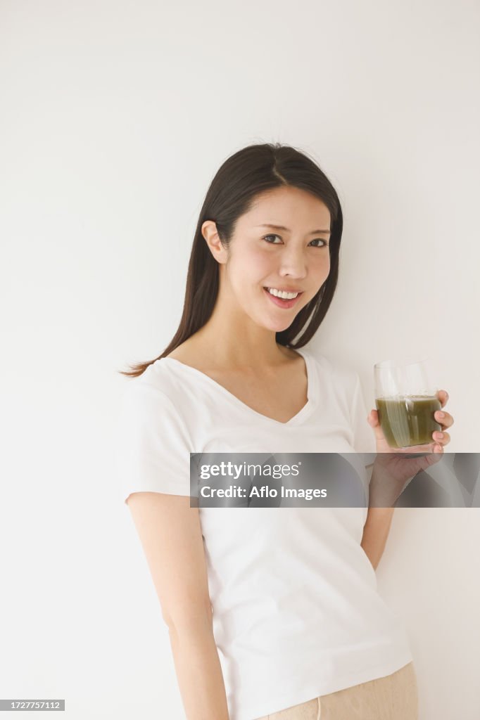 Portrait of young Japanese woman in a white room