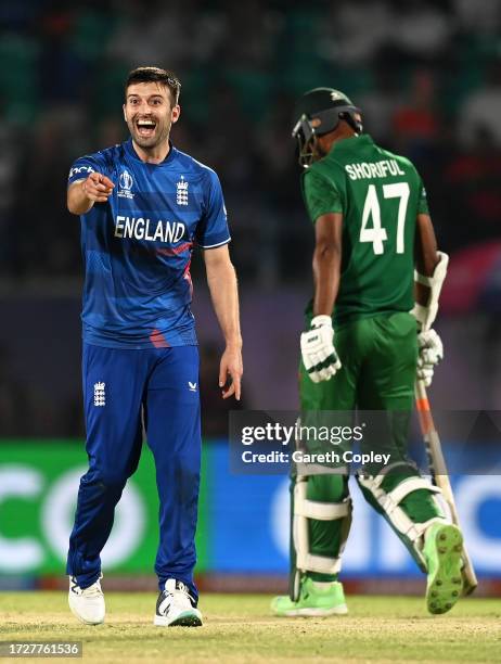 Mark Wood of England celebrates after bowling Shoriful Islam of Bangladesh during the ICC Men's Cricket World Cup India 2023 between England and...