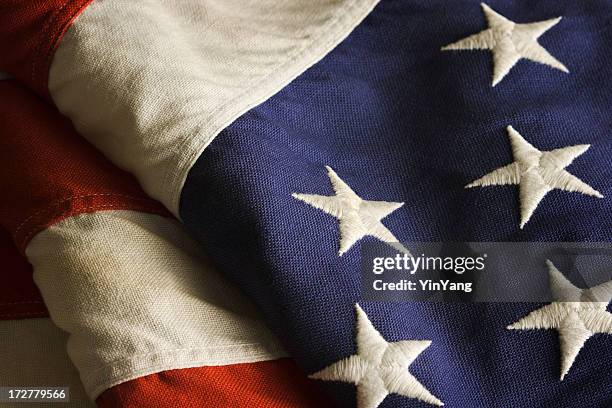 american flag, close-up of weathered, old, embroidered usa national banner - veterans day stock pictures, royalty-free photos & images