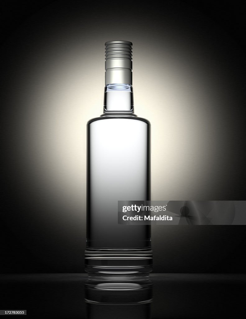 Clear vodka bottle isolated on black and gray background