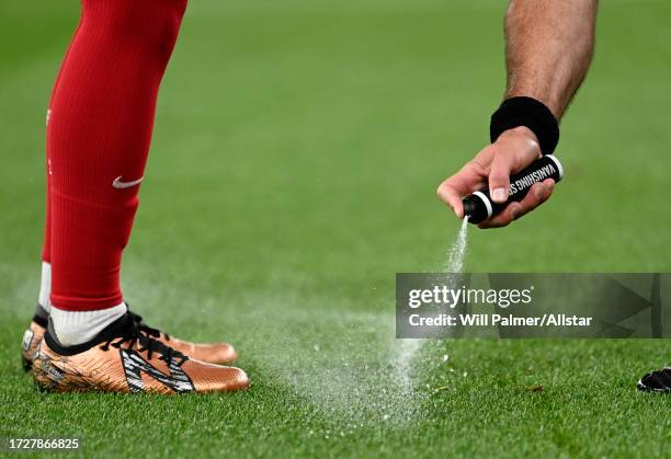 Referee sprays vanishing spray during the Carabao Cup Third Round match between Liverpool FC and Leicester City at Anfield on September 27, 2023 in...