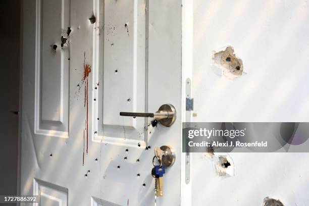 Gunshots and blood stains are seen on a door and walls of a house where civilians were killed days earlier in an attack by Hamas militants on this...