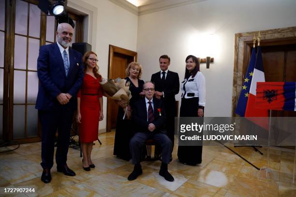Renowned Albanian writer Ismail Kadare poses next to Albanian Prime Minister Edi Rama with his wife Linda Rama and members of his family after...